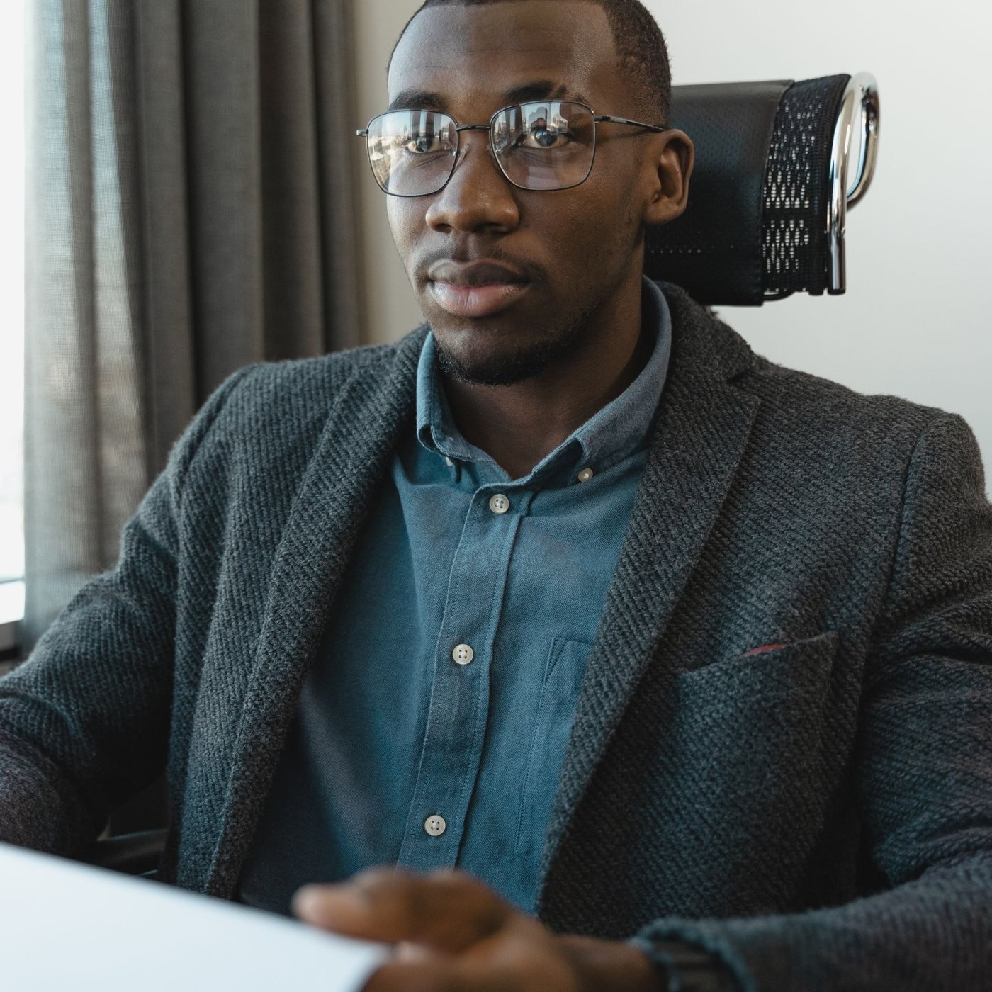 A professional in an interview across a desk